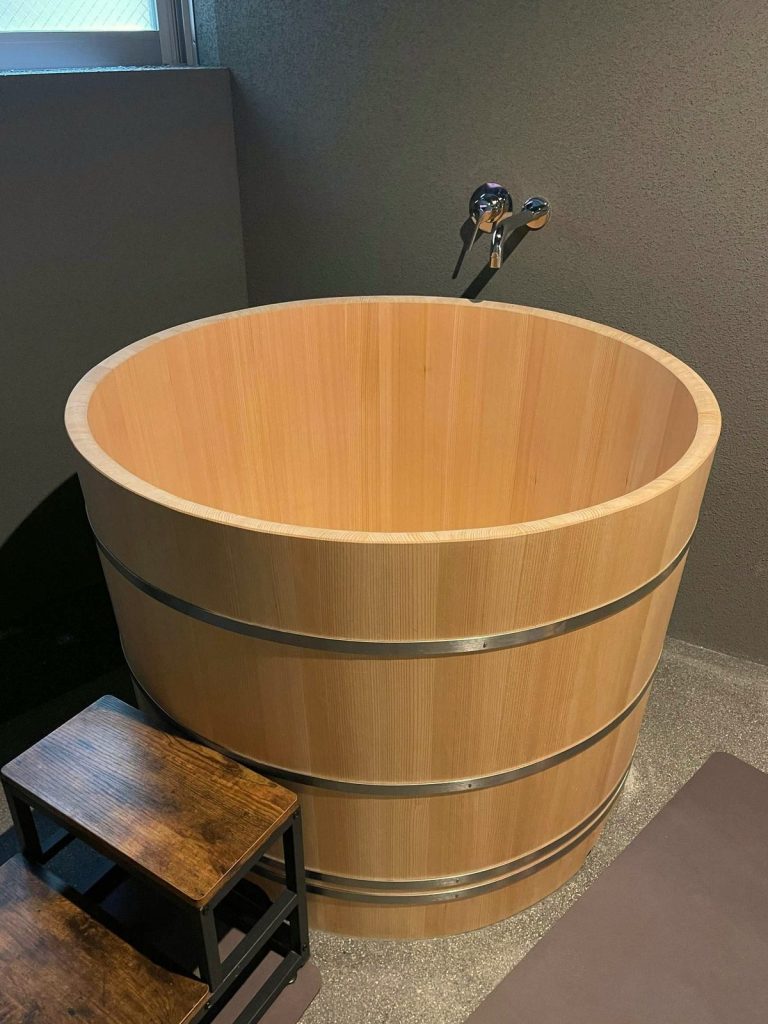 Japanese-style cedar soaking tub installed indoors