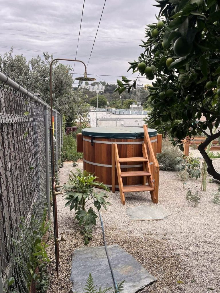Outdoor cedar soaking tub with wooden steps