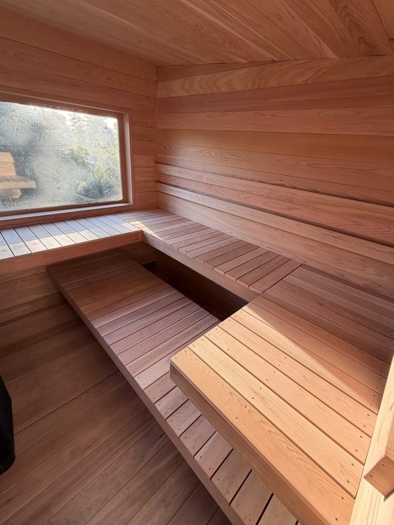 Light cedar sauna interior with a window for daylight