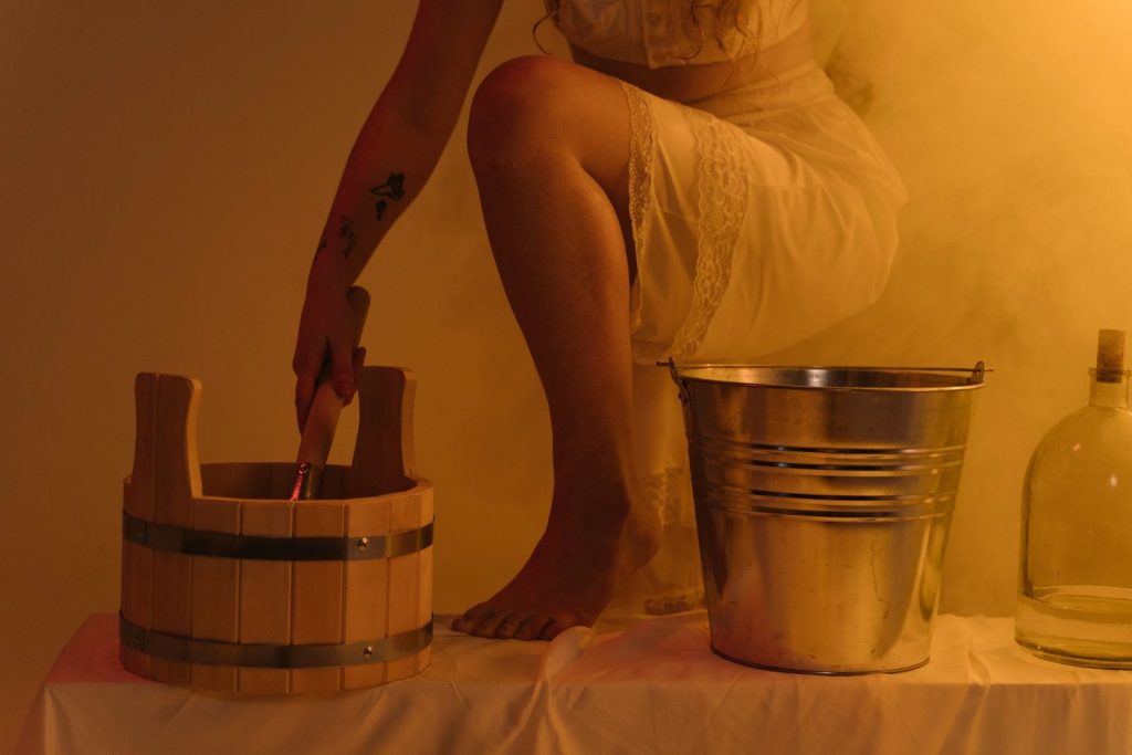 Sauna buckets and accessories under amber light